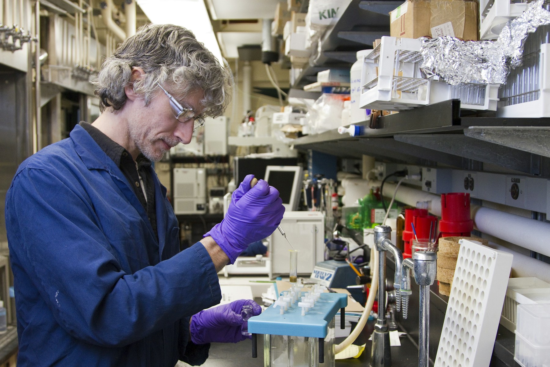 A laboratory researcher handling a sample with a pipette.