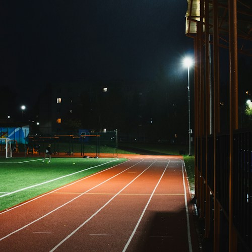 A stadium running track, shown as an illustrative placeholder for the Games programme